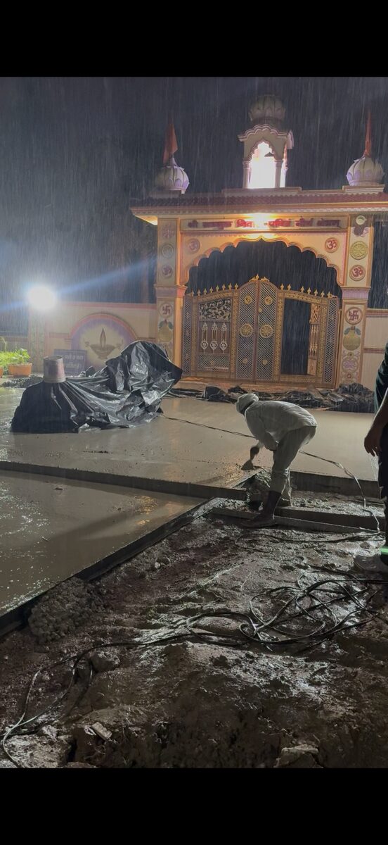 Concrete flooring construction by Braj Builders at a temple courtyard